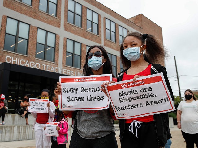 Protesters hold signs during the Occupy City Hall Protest and Car Caravan hosted by Chicag