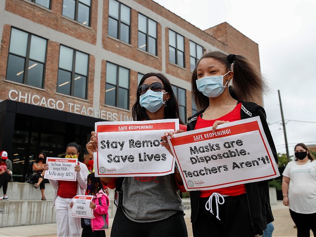 Protesters hold signs during the Occupy City Hall Protest and Car Caravan hosted by Chicago Teachers Union in Chicago, Illinois, on August 3, 2020. - Teachers and activists hold car caravan all over the country on August 3, 2020 to demand adequate classroom safety measures as schools debate reopening. (Photo by KAMIL KRZACZYNSKI / AFP) (Photo by KAMIL KRZACZYNSKI/AFP via Getty Images)