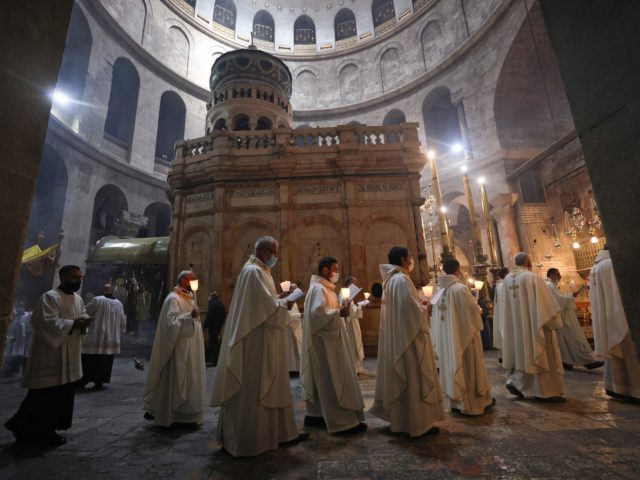 TOPSHOT - Fransiscan friars march in procession during a mass to commemorate the Washing of the Feet around the Edicule, traditionally believed to be the burial site of Jesus Christ, on Holy Thursday at the Church of the Holy Sepulchre in Jerusalem, on April 1, 2021. - Holy Thursday or …