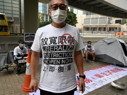 Members of a group representing bar, karaoke and mahjong parlour owners take part in a symbolic four-day hunger strike outside the government's headquarters in Hong Kong on April 5, 2021, over anti-coronavirus measures which have kept their industries shuttered for most of the last year. (Photo by Peter PARKS / …