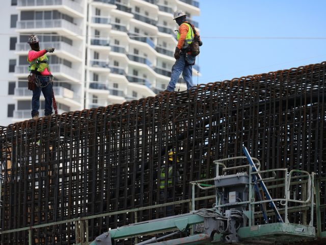 MIAMI, FLORIDA - MARCH 17: Construction workers build the “Signature Bridge,” replacing and improving a busy highway intersection at I-95 and I-395 on March 17, 2021 in Miami, Florida. The Florida Department of Transportation is building the project in partnership with the Miami-Dade Expressway Authority and its contractor, the Archer …