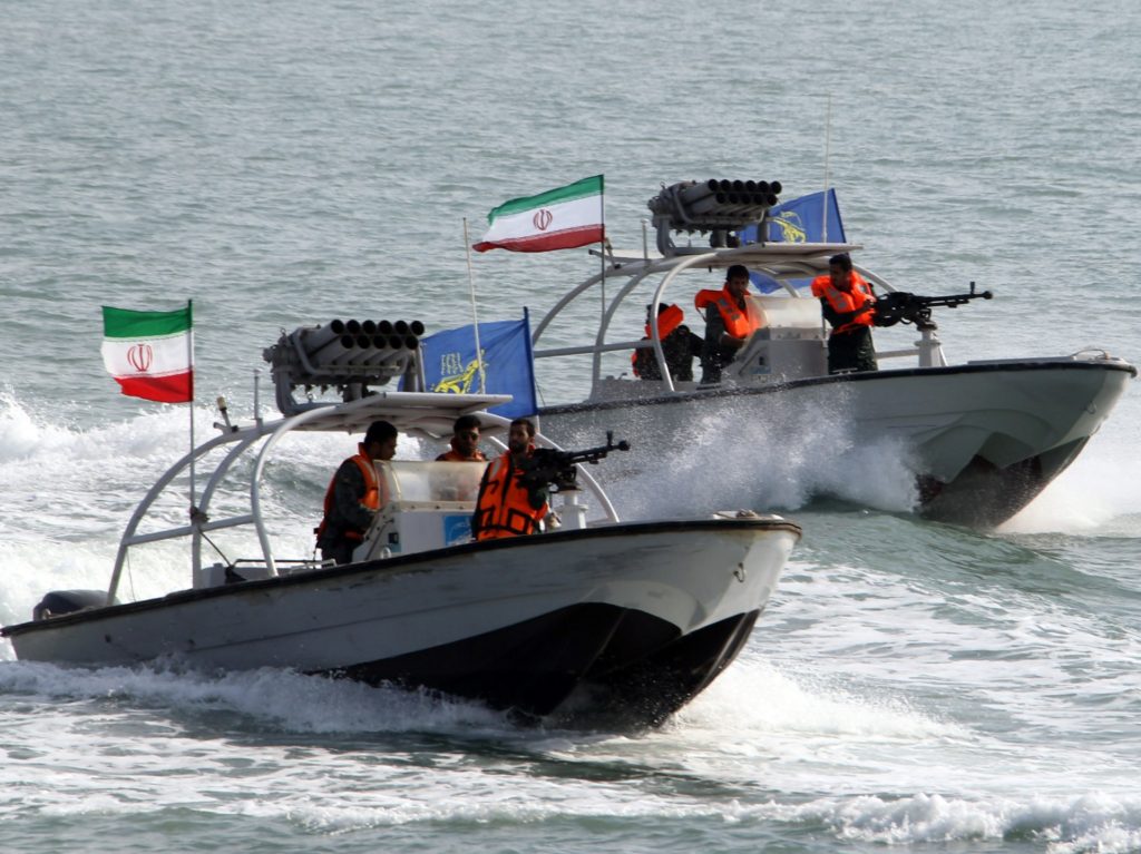 Iranian Revolutionary Guards drive speedboats during a ceremony to commemorate the 24th anniversary of the downing of Iran Air flight 655 by the US navy, at the port of Bandar Abbas on July 2, 2012. The plane was shot down by mistake over the Gulf by the US navy's guided missile cruiser, USS Vincennes, during confrontation with Iranian speedboats on July 3, 1988, killing 290 civilian passengers and crew members. AFP PHOTO/ATTA KENARE (Photo credit should read ATTA KENARE/AFP/GettyImages)
