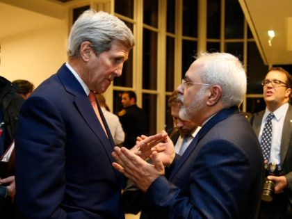 US Secretary of State John Kerry (L) speaks with Iranian Foreign Minister Mohammad Javad Zarif after the International Atomic Energy Agency (IAEA) verified that Iran has met all conditions under the nuclear deal during the E3/EU+3 and Iran talks in Vienna on January 16, 2016. The historic nuclear accord between …