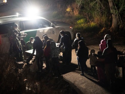 ROMA, TX - APRIL 22: Asylum-seeking migrants' families wait to be transported by the U.S. Border Patrol after crossing the Rio Grande river into the United States from Mexico on April 22, 2021 in Roma, Texas. A surge of mostly Central American immigrants crossing into the United States, including record …