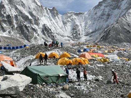 In this photograph taken on April 25, 2018, trekkers and porters gather at Everest Base Camp, some 140km northeast of the Nepali capital Kathmandu. - Hundreds of adventurers have been granted permits to climb Mount Everest, officials said April 26, 2018, foreshadowing another bumper year despite concerns about overcrowding on …