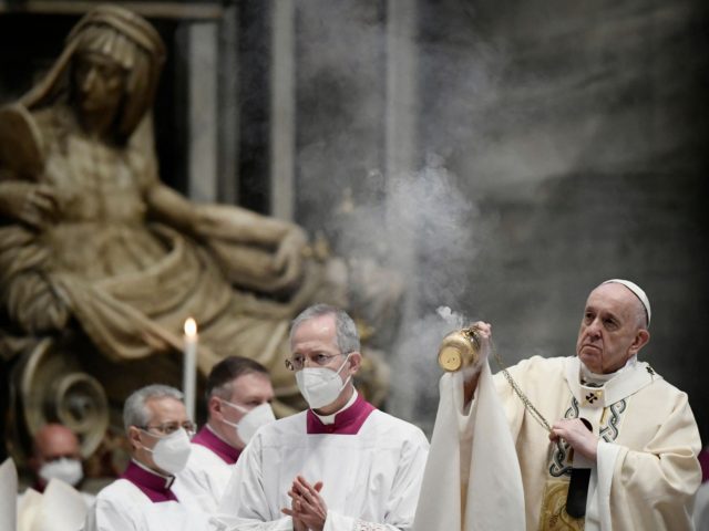 Pope Francis swings a thurible of incense as he prepares to celebrate the Eucharist during