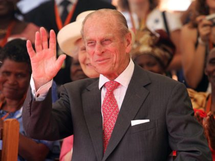 KAMPALA, UGANDA - NOVEMBER 22: HRH Prince Philip, The Duke of Edinburgh waves as he watches AIDS orphans perform a fashion show at the Mildmay centre for AIDS Orphans on November 22, 2007 in Kampala, Uganda. The Queen will open the Commonwealth Heads of Government Meeting on Friday. CHOGM will …
