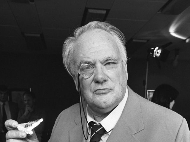 British astronomer and television presenter Patrick Moore with some cake on April 21, 1982