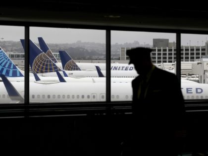 SAN FRANCISCO, CALIFORNIA - APRIL 12: A pilot walks by United Airlines planes as they sit