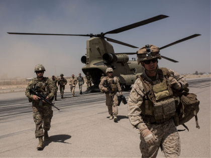 CAMP BOST, AFGHANISTAN - SEPTEMBER 11: U.S. service members walk off a helicopter on the runway at Camp Bost on September 11, 2017 in Helmand Province, Afghanistan. About 300 marines are currently deployed in Helmand Province in a train, advise, and assist role supporting local Afghan security forces. Currently the …