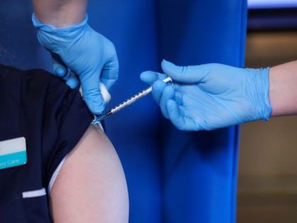 HAMILTON, SCOTLAND - DECEMBER 14: A member of staff receives the Pfizer/BioNTech COVID-19 vaccine at the Abercorn House Care Home on December 14, 2020 in Hamilton, Scotland. (Photo by Russell Cheyne - WPA Pool/Getty Images)