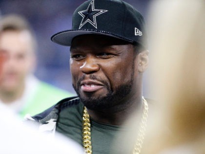 Rap artist 50Cent, wears a Dallas Cowboys cap as he stands on the sideline watching the Cowboys and Chicago Bears warm up before an NFL football game, Sunday, Sept. 25, 2016, in Arlington, Texas. (AP Photo/Ron Jenkins)