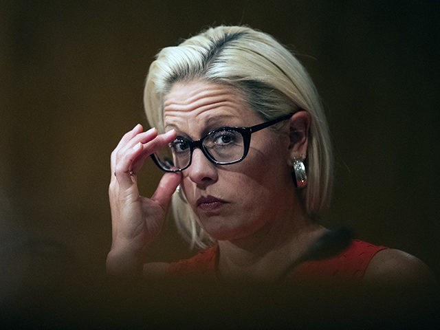 Senate Security and Governmental Affairs Committee member Sen. Kyrsten Sinema, D-Ariz., adjusts her eyeglasses during a hearing on 2020 census on Capitol Hill in Washington, Tuesday, July 16, 2019. (AP Photo/Manuel Balce Ceneta)