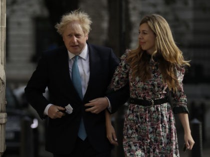 British Prime Minister Boris Johnson arrives at a polling station with his partner Carrie Symonds to cast his vote in local council elections in London, Thursday May 6, 2021. Millions of people across Britain will cast a ballot on Thursday, in local elections, the biggest set of votes since the …