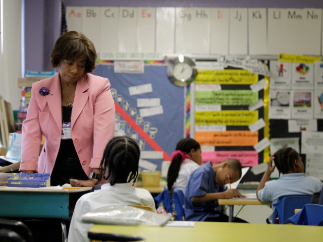 In this March 25, 2010 photo, Experience Corps tutor Elizabeth Dorsey helps a student at Belmont Elementary in Baltimore. Experience Corps operates in 22 cities nationwide and trains volunteers over 55 to tutor and mentor elementary school students. (AP Photo/Rob Carr)