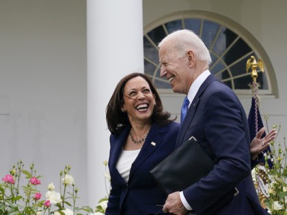 President Joe Biden walks with Vice President Kamala Harris after speaking on updated guid