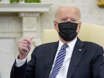 President Joe Biden snaps his fingers as he responds to a reporters question during a meet