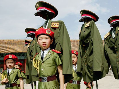 BEIJING - JUNE 1: Chinese children dressed in replica military uniforms wait to perform a dance to mark International Children's Day on June 1, 2005 in Beijing, China. (Photo by Guang Niu/Getty Images)