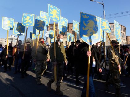 Ukrainian nationalists carry emblems of the so-called Galychyna Division during a commemorating march in Kyiv, Ukraine, Wednesday, April 28, 2021. The 14th Waffen Grenadier Division of the SS, called also Galychyna Division, was a World War II German military formation initially made up of volunteers from the region of Galycia …