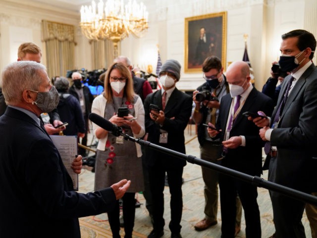 Dr. Anthony Fauci, director of the National Institute of Allergy and Infectious Diseases, talks with reporters before an event with President Joe Biden on the coronavirus in the State Dinning Room of the White House, Thursday, Jan. 21, 2021, in Washington. (AP Photo/Alex Brandon)