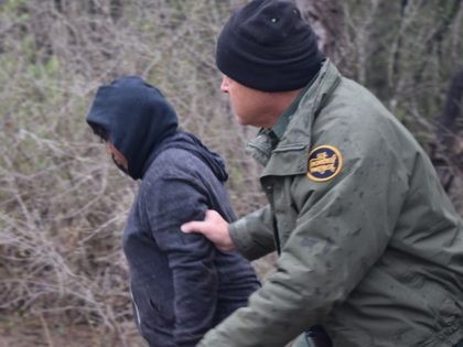 Border Patrol agents arrest a female migrant after she illegally crossed the border in to Texas. (File Photo: Bob Price/Breitbart Texas)