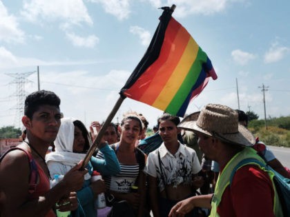 JUCHITAN DE ZARAGOZA, MEXICO - NOVEMBER 01: Members of an LGBT group traveling with the other Central American migrant caravan wait for a ride on November 01, 2018 in Juchitan de Zaragoza, Mexico. The group of migrants, many of them fleeing violence in their home countries, took a rest day …