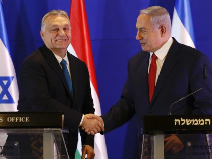 Hungarian Prime Minister Viktor Orban (L) and Israeli Prime Minister Benjamin Netanyahu shake hands during a press conference after their meeting in Jerusalem on February 19, 2019. - Netanyahu seeks to save face after a summit with four central European nations is cancelled over a Holocaust-linked dispute with Poland, instead …