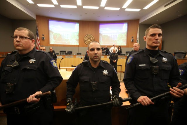 SACRAMENTO, CALIFORNIA - MARCH 05: Sacramento police officers guard the dais as activists