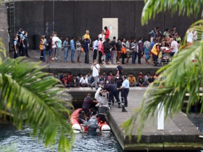 French gendarmes are at work to disembark migrants from a boat, on April 13, 2019 in Sainte-Rose, on the French Indian ocean island of La Reunion, after the boat, carrying some 120 migrants, allegedly from Sri Lanka, was intercepted by French authorities. (Photo by Richard BOUHET / AFP) (Photo credit …