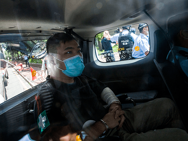 A 23-year-old man, Tong Ying-kit, arrives at a court in a police van in Hong Kong Monday, July 6, 2020. Tong has become the first person in Hong Kong to be charged under the new national security law, for allegedly driving a motorcycle into a group of policemen while bearing …