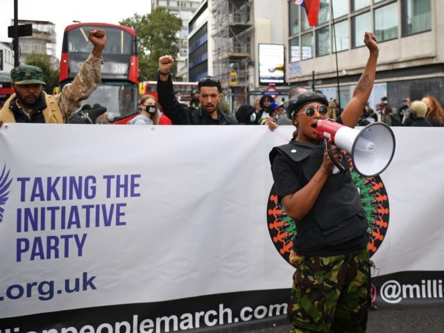 People gather in Westbourne Park to take part in the inaugural Million People March march from Notting Hill to Hyde Park in London on August 30, 2020, to put pressure on the UK Government into changing the "UK's institutional and systemic racism". - The march is organised by The Million …