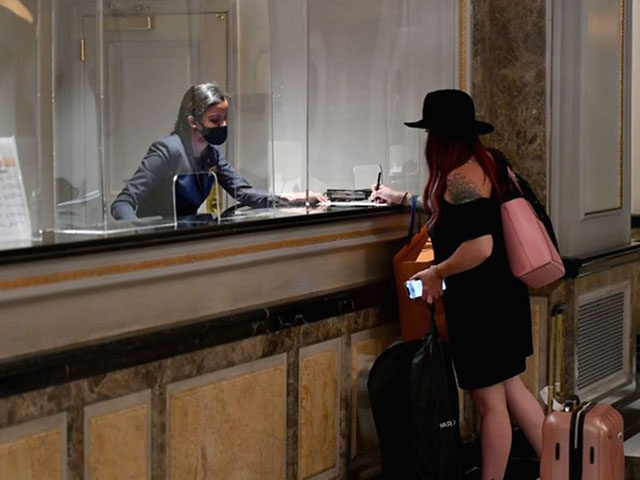 A hotel guest stands at the front desk at The Pierre, A Taj Hotel, New York on September 2