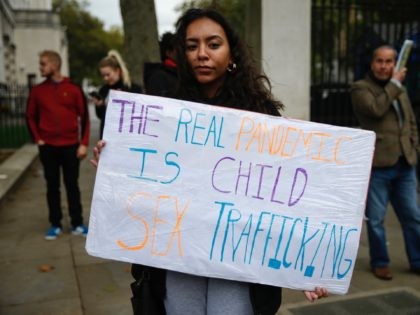 LONDON, ENGLAND - OCTOBER 10: A protestor holds a sign during a "Save our Children" rally outside Downing Street on October 10, 2020 in London, England. During the demonstration, protesters held signs which called for an end to child sex trafficking and made references to "Pizzagate". (Photo by Hollie Adams/Getty …