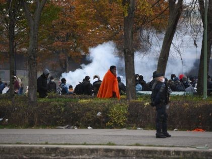 French police arrive to evacuate a migrant camp of some 2000 people near the A1 motorway w