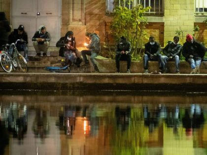 TOPSHOT - Crack smokers light their crack pipes on the docks at Stalingrad Square, nicknamed Stalincrack, on December 2, 2020 in Paris. - This "drug of the poor" has been wreaking havoc in the north-east of the capital for thirty years. Over the past 18 months, the authorities have been …