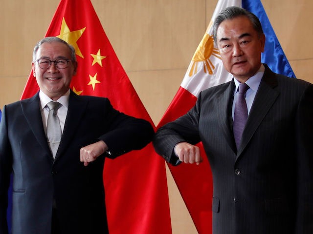 Chinese Foreign Minister Wang Yi (R) and Philippine Foreign Affairs secretary Teodoro Locs