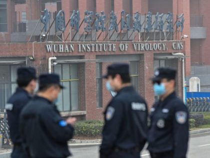 lab leak--Security personnel stand guard outside the Wuhan Institute of Virology in Wuhan as members of the World Health Organization (WHO) team investigating the origins of the COVID-19 coronavirus make a visit to the institute in Wuhan in China's central Hubei province on February 3, 2021. (Photo by Hector RETAMAL …