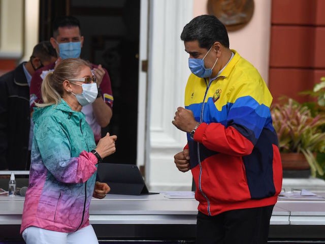Venezuelan President Nicolas Maduro and First Lady Cilia Flores dance as they arrive to a meeting to commemorate the International Youth Day at the Miraflores Presidential Palace in Caracas, on February 12, 2021. (Photo by Federico PARRA / AFP) (Photo by FEDERICO PARRA/AFP via Getty Images)