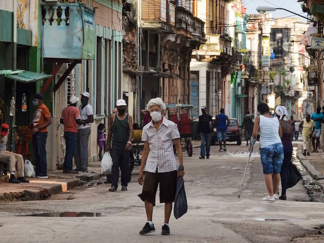 An elderly person wearing a face mask walks along a street of Havana, on April 6, 2021. - Amidst long queues for food and the effects of the pandemic, Cubans view without much hope the change of baton between Raul Castro and Miguel Diaz-Canel as first secretary of the Cuban …