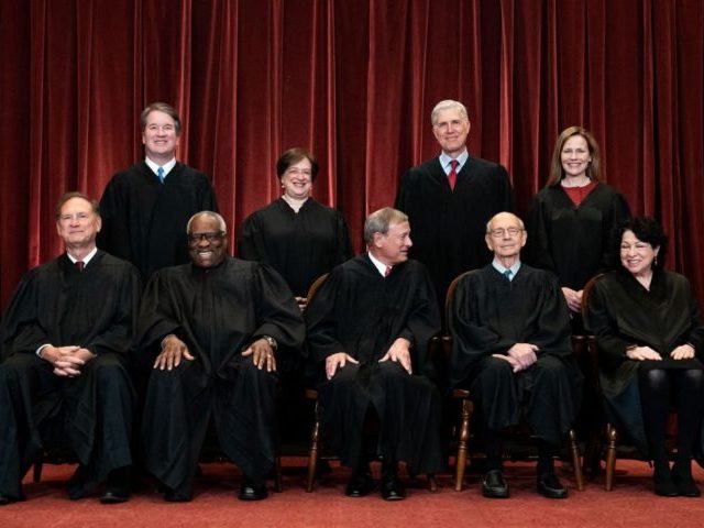 Seated from left: Associate Justice Samuel Alito, Associate Justice Clarence Thomas, Chief Justice John Roberts, Associate Justice Stephen Breyer and Associate Justice Sonia Sotomayor, standing from left: Associate Justice Brett Kavanaugh, Associate Justice Elena Kagan, Associate Justice Neil Gorsuch and Associate Justice Amy Coney Barrett pose during a group photo …