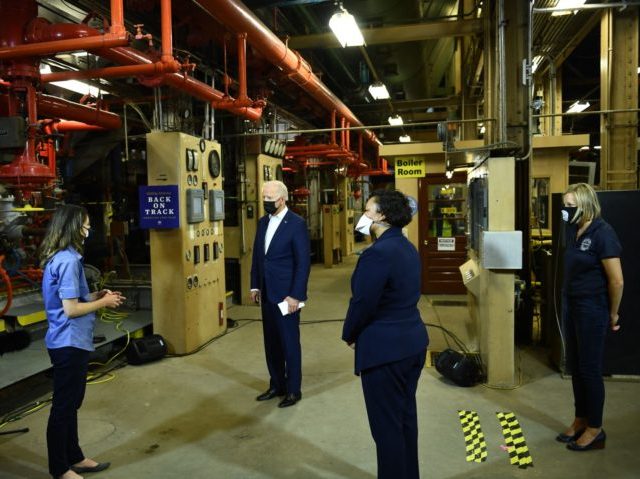 US President Joe Biden and Mayor of New Orleans LaToya Cantrell listen as they tour the Ca