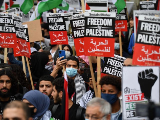 Pro-Palestinian activists gesture during a demonstration protesting against Israeli attacks on Palestinians after at least 28 people were killed following clashes over the flashpoint Al-Aqsa mosque in Jerusalem, outside Downing Street in central London on May 11, 2021. (Photo by JUSTIN TALLIS / AFP) (Photo by JUSTIN TALLIS/AFP via Getty …