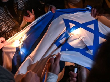 Protesters set an Israeli flag on fire during a demonstration against Israel in front of t