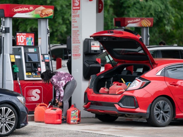 BENSON, NC - MAY 12: A woman fills gas cans at a Speedway gas station on May 12, 2021 in Benson, North Carolina. Most stations in the area along I-95 are without fuel following the Colonial Pipeline hack. The 5,500 mile long pipeline delivers a large percentage of fuel on …
