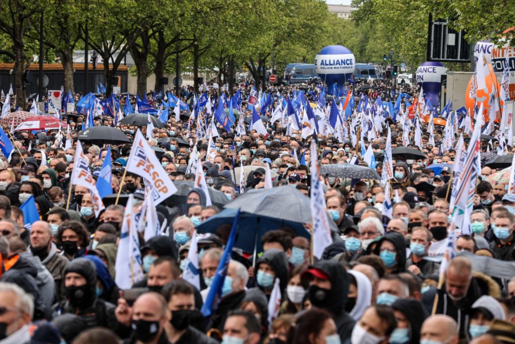 Police officers wave flags of police unions as they gather for a rally in Paris on May 19, 2021, to demand harsher punishment for attacks against their own, two weeks after an officer was shot dead while investigating drug deals. (Photo: THOMAS COEX/AFP via Getty Images)