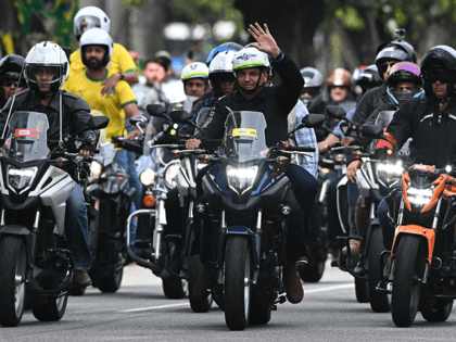 Brazilian President Jair Bolsonaro (C) gestures as he heads a motorcade rally with his sup