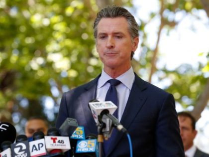 California Governor Gavin Newsom takes a moment to compose his emotions as he speaks durin