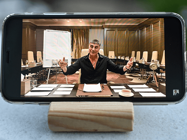A photograph taken on May 26, 2021 in Istanbul shows on a mobile phone Sedat Peker speaking on his youtube channel. - Millions of Turks have been glued to their screens, watching a mobster tell wild stories about international drug smuggling, murders and the murky ties between politicians and the …