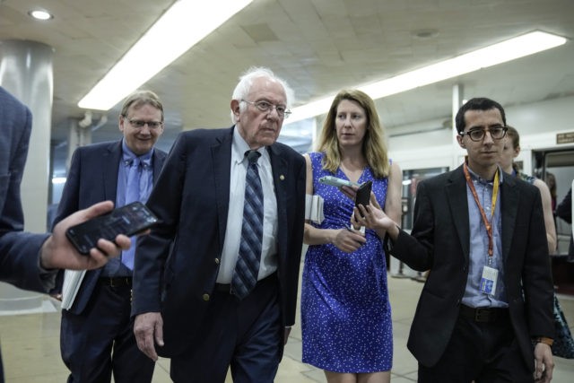 WASHINGTON, DC - MAY 27: Sen. Bernie Sanders (I-VT) talks with reporters as he walks throu