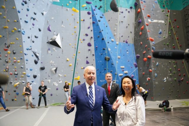 US President Joe Biden visits the Sportrock Climbing Centers alongside its owner Lillian Chao-Quinlan (R), and Virginia Governor Ralph Northam, in Alexandria, Virginia on May 28, 2021. (Photo by MANDEL NGAN / AFP) (Photo by MANDEL NGAN/AFP via Getty Images)